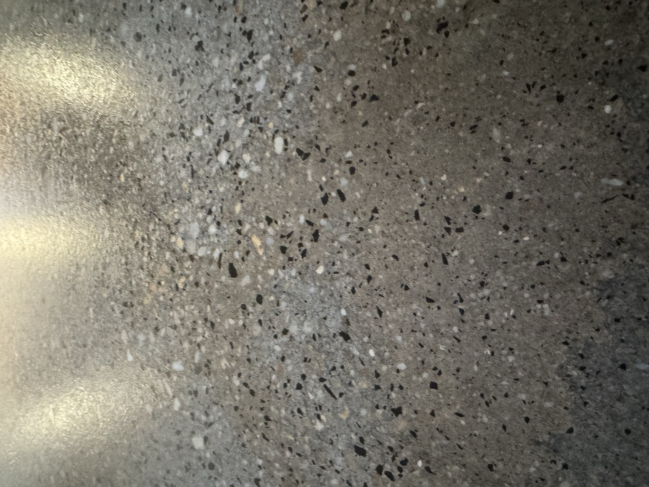 Close up of a light exposure grind and seal floor, satin sheen